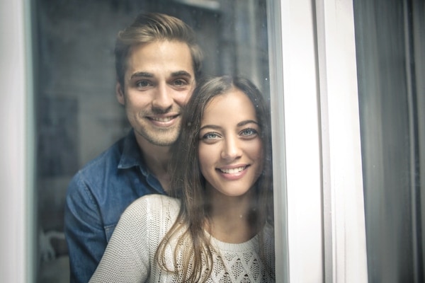 Cheerful couple looking out of the window